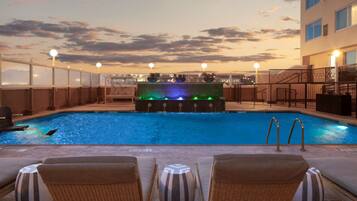 Relax by the pool with lounge chairs and a clear view of the water.