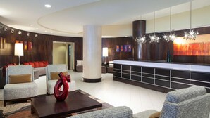 A lobby with seating, a reception desk, and artwork on the walls. - DoubleTree by Hilton El Paso Downtown (El Paso)