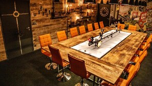 A conference room with a large wooden table, orange chairs, and a clock on the wall. - Hôtel Mercure Nantes Ouest Saint-Herblain Zenith (Saint-Herblain)