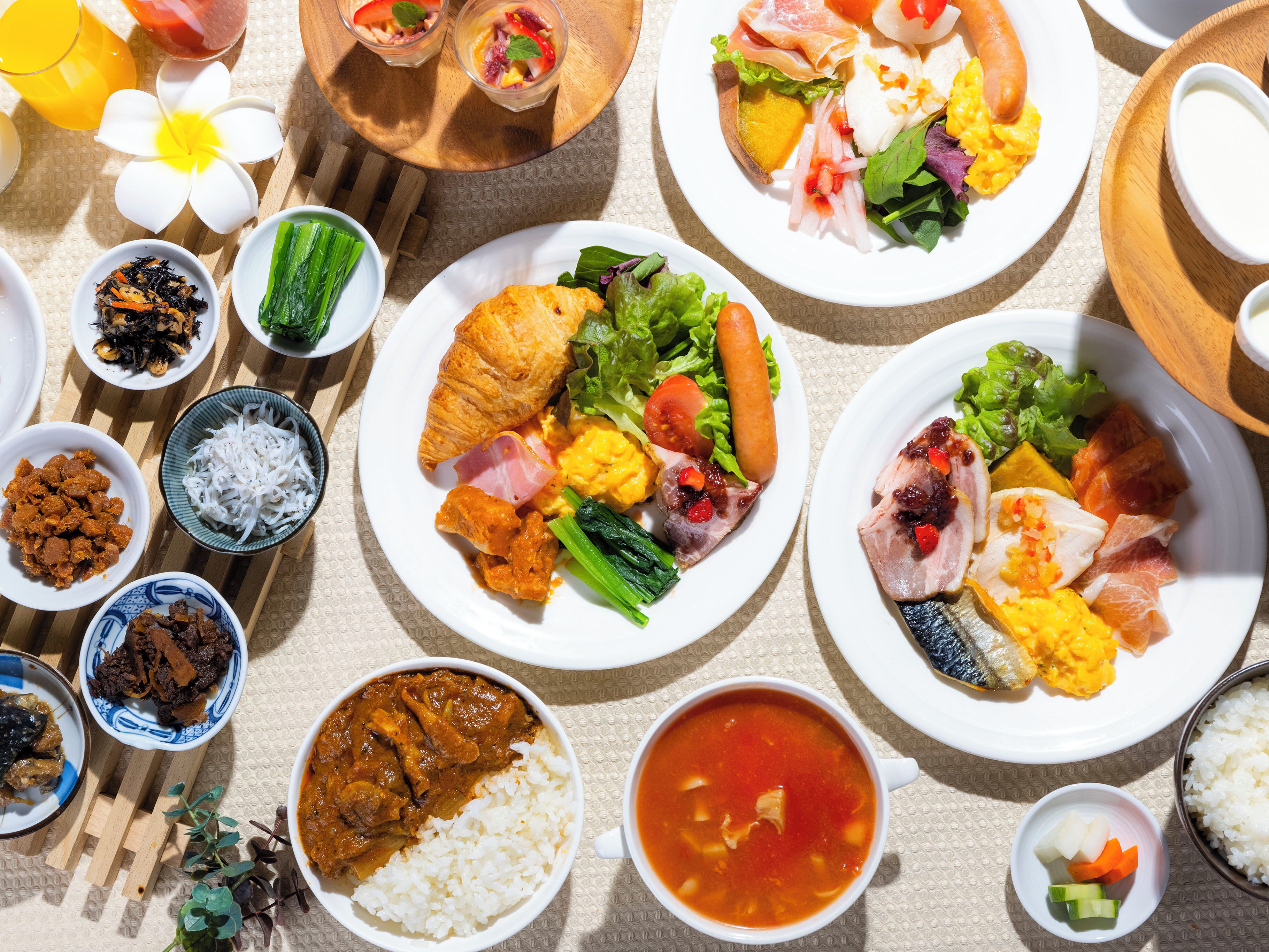 A variety of dishes including rice, soup, and multiple plates of food.