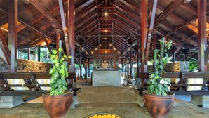 A covered area with a central altar, potted plants, and a stone bench. - Club Mahindra Madikeri, Coorg (Madikeri)