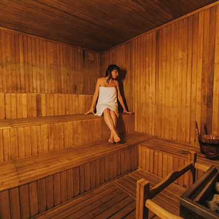 A wooden sauna with benches and a wooden bench.