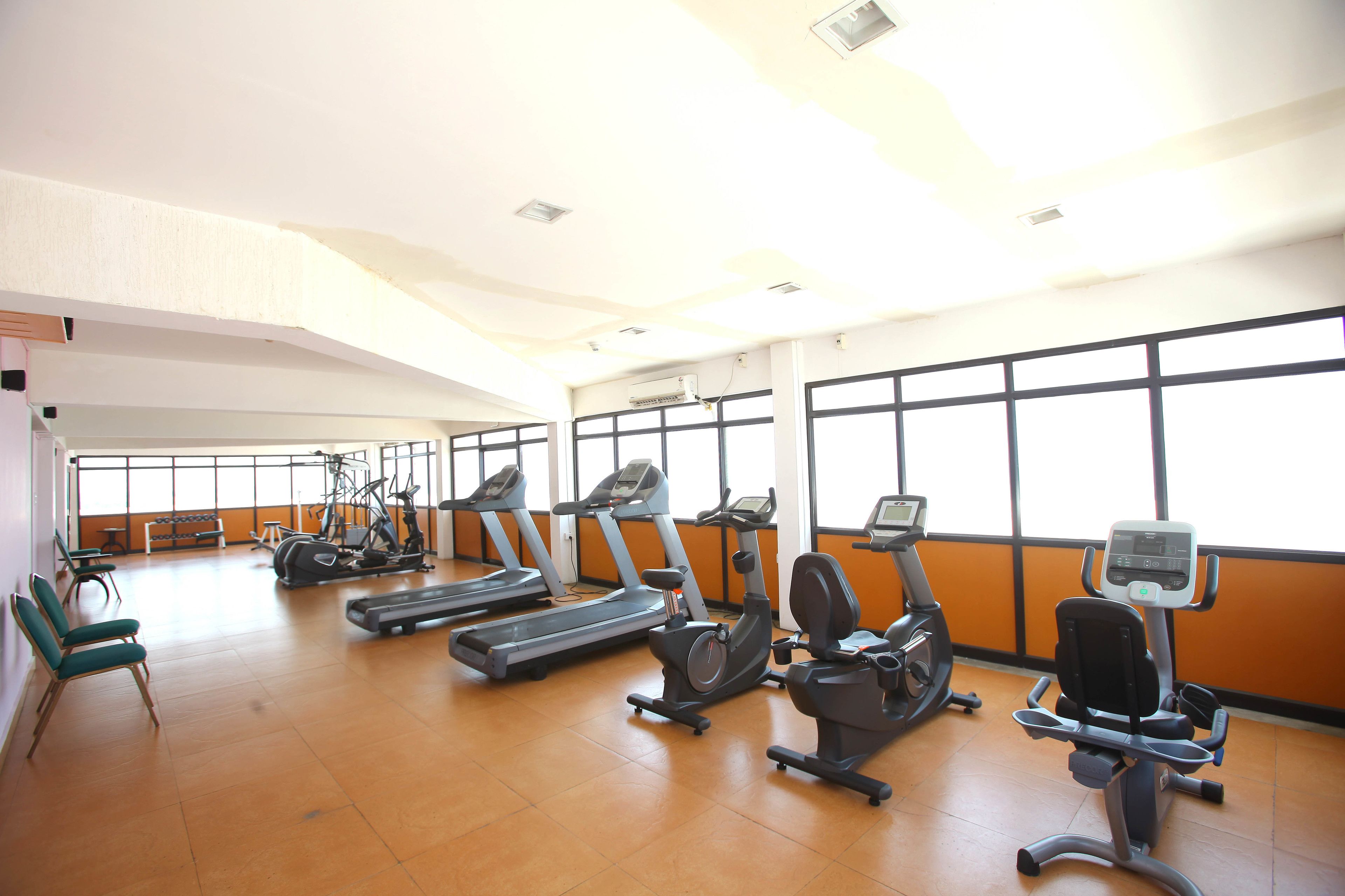 A gym with treadmills, stationary bikes, and exercise equipment.
