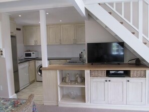 Full-size fridge, microwave, stovetop, cookware/dishes/utensils