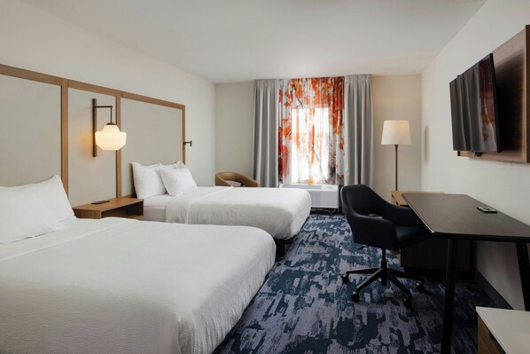 A hotel room with two beds, a desk, a chair, a TV, and a window with curtains. - Fairfield Inn & Suites by Marriott Fort Wayne (Fort Wayne)
