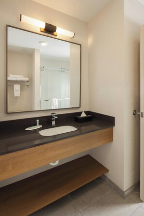 A modern bathroom with a large mirror, a sink, and a towel rack. - Fairfield Inn & Suites by Marriott Fort Wayne (Fort Wayne)