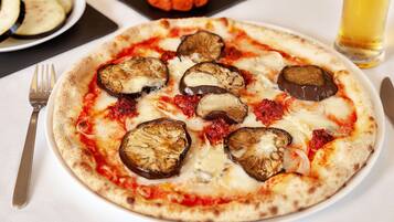 A pizza with various toppings on a white plate.