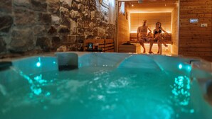 A stone-walled sauna with a wooden interior and a hot tub in the foreground. - Villa di Sotto (Castelnuovo Berardenga)