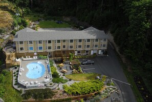 A resort with a swimming pool, outdoor seating, and a parking area. - High Point Resort (Quadra Island)