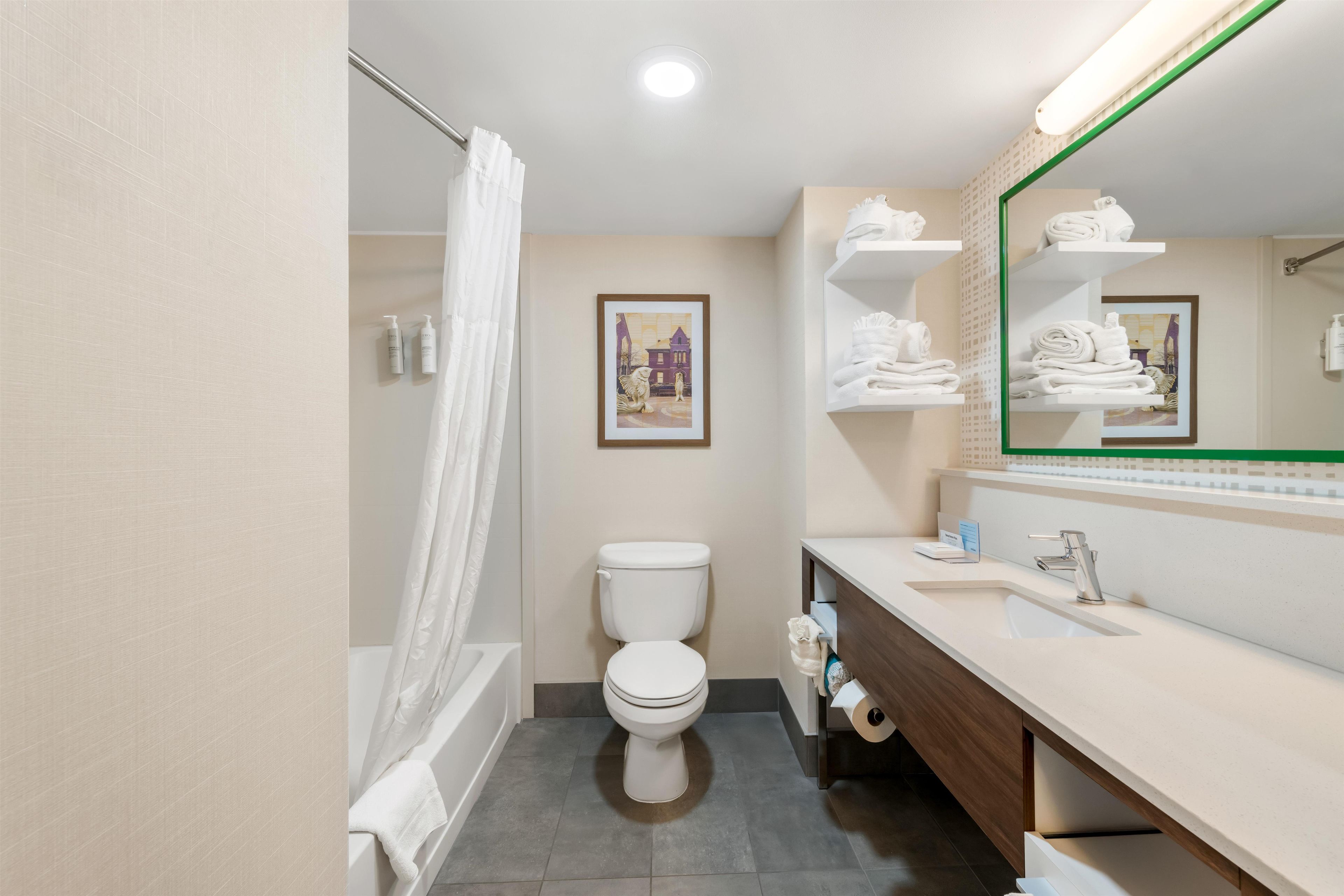 A modern bathroom with a toilet, sink, and shower area.