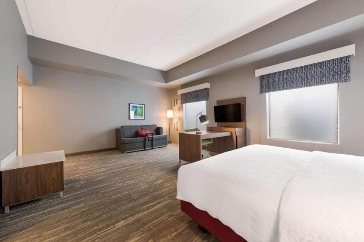 Escritorio, cortinas blackout y tabla de planchar con plancha