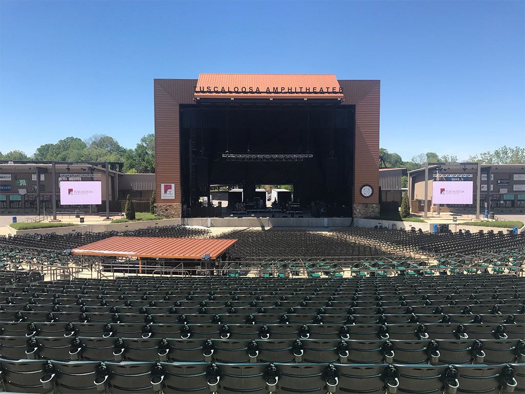 An amphitheater with tiered seating and a stage.