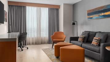 King Bedroom Evolution Suite | Living area | 55-inch LCD TV with cable channels, Netflix, streaming services