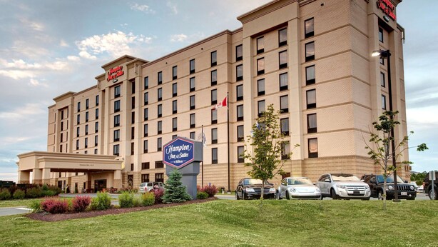 A Hampton Inn hotel with a large sign, multiple parking spaces, and a well-maintained lawn. - Hampton Inn & Suites by Hilton Halifax - Dartmouth (Dartmouth)