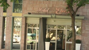 A hotel entrance with a sign reading "Hotel Elves." - Hotel Elvezia (Pesaro)