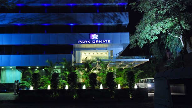 A hotel entrance with a sign reading "PARK ORNATE" and a modern building facade. - Park Ornate (Pune)
