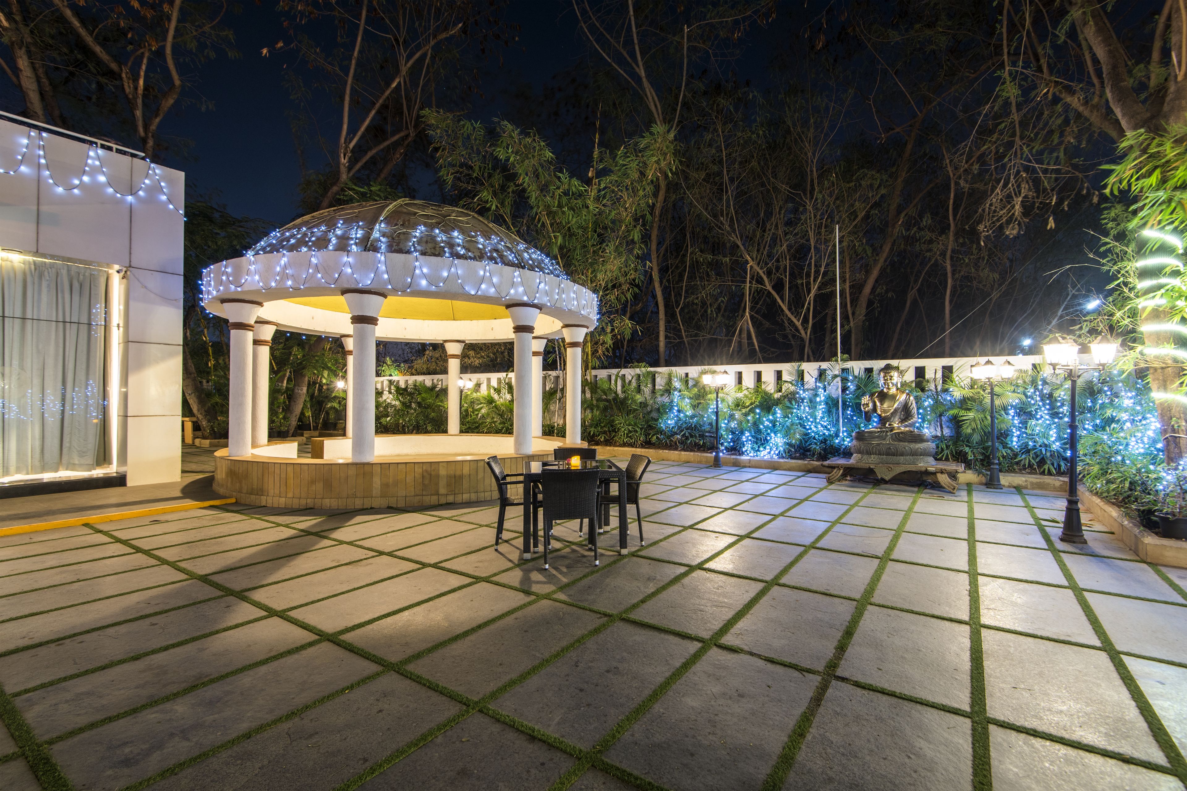 A gazebo with a tiled patio and outdoor seating.