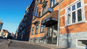 A hotel with a brick facade, large windows, and a sign indicating it is the Prinsen Hotel. - Prinsen Hotel (Aalborg)