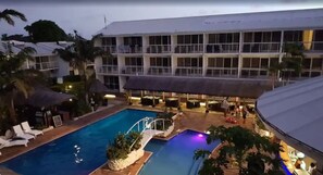 A hotel with a swimming pool, outdoor seating, and a covered area. - The Melanesian Port Vila Hotel (Port Vila)