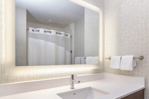 A bathroom with a white sink, a mirror, and a shower curtain. - Holiday Inn Express Hotel & Suites Banning by IHG (Banning)