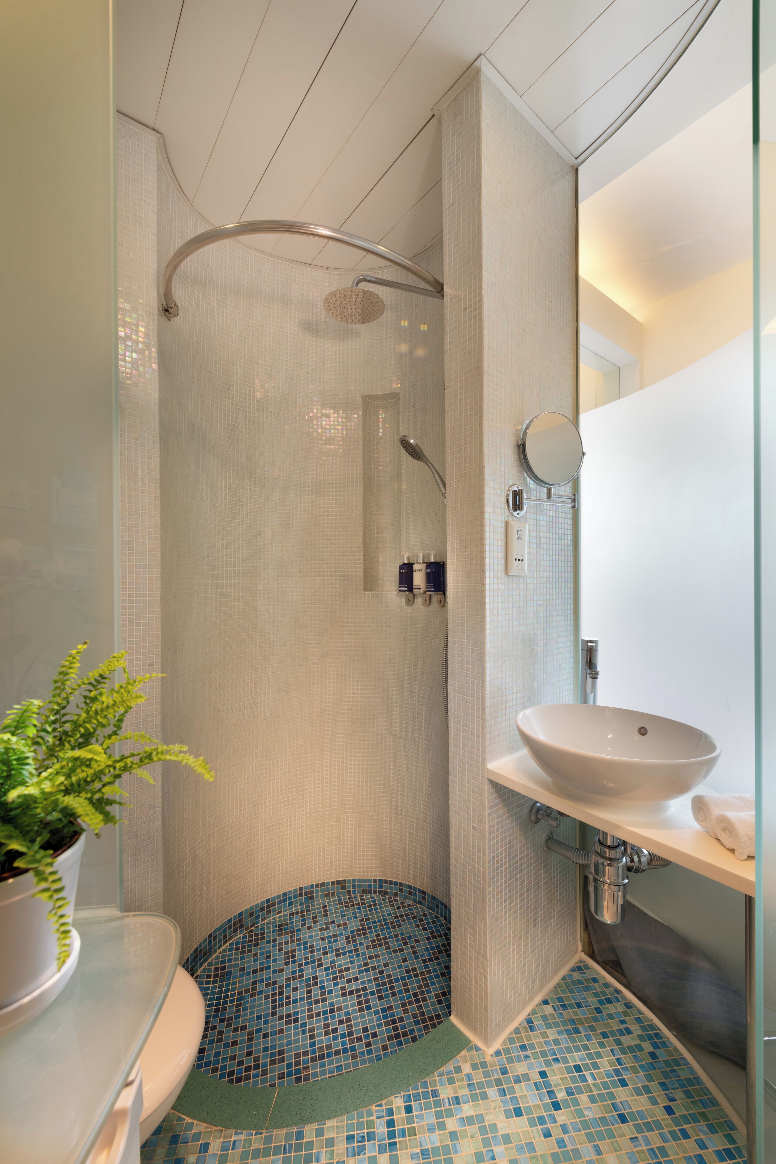 shower, hair dryer, slippers, towels