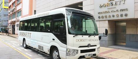 A white Dorsett bus parked on a city street.