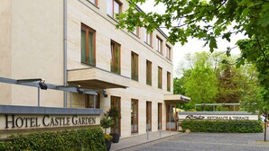 A hotel named "Hotel Castle Garden" with a sign for "Ristorante & Terrace" and a paved entrance area. - Hotel Castle Garden (Budapest)