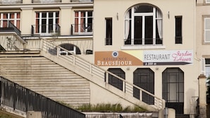 A building with a staircase leading to a restaurant named "Residence Beaussieux." - Le Beausejour (Plombieres-les-Bains)