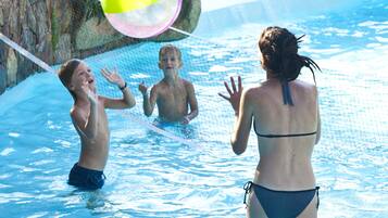 Guests can enjoy a refreshing swim in the pool surrounded by a stone wall.