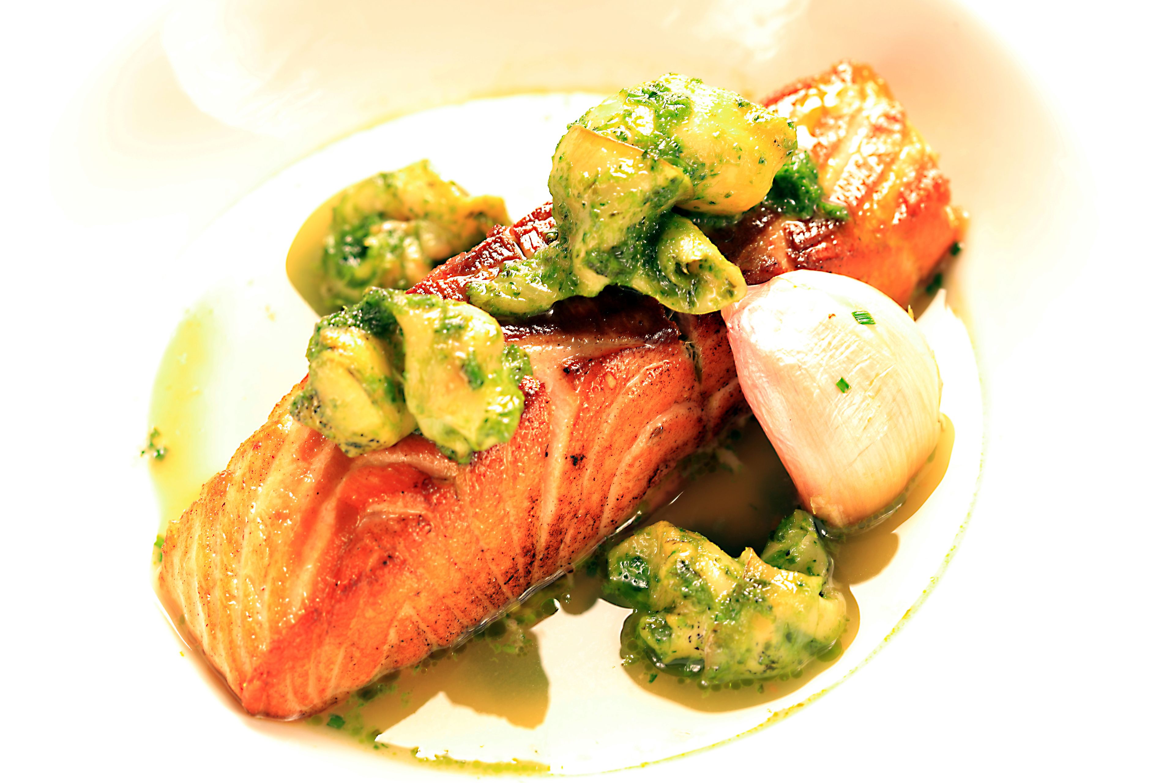 A plate with salmon, broccoli, and a poached egg.