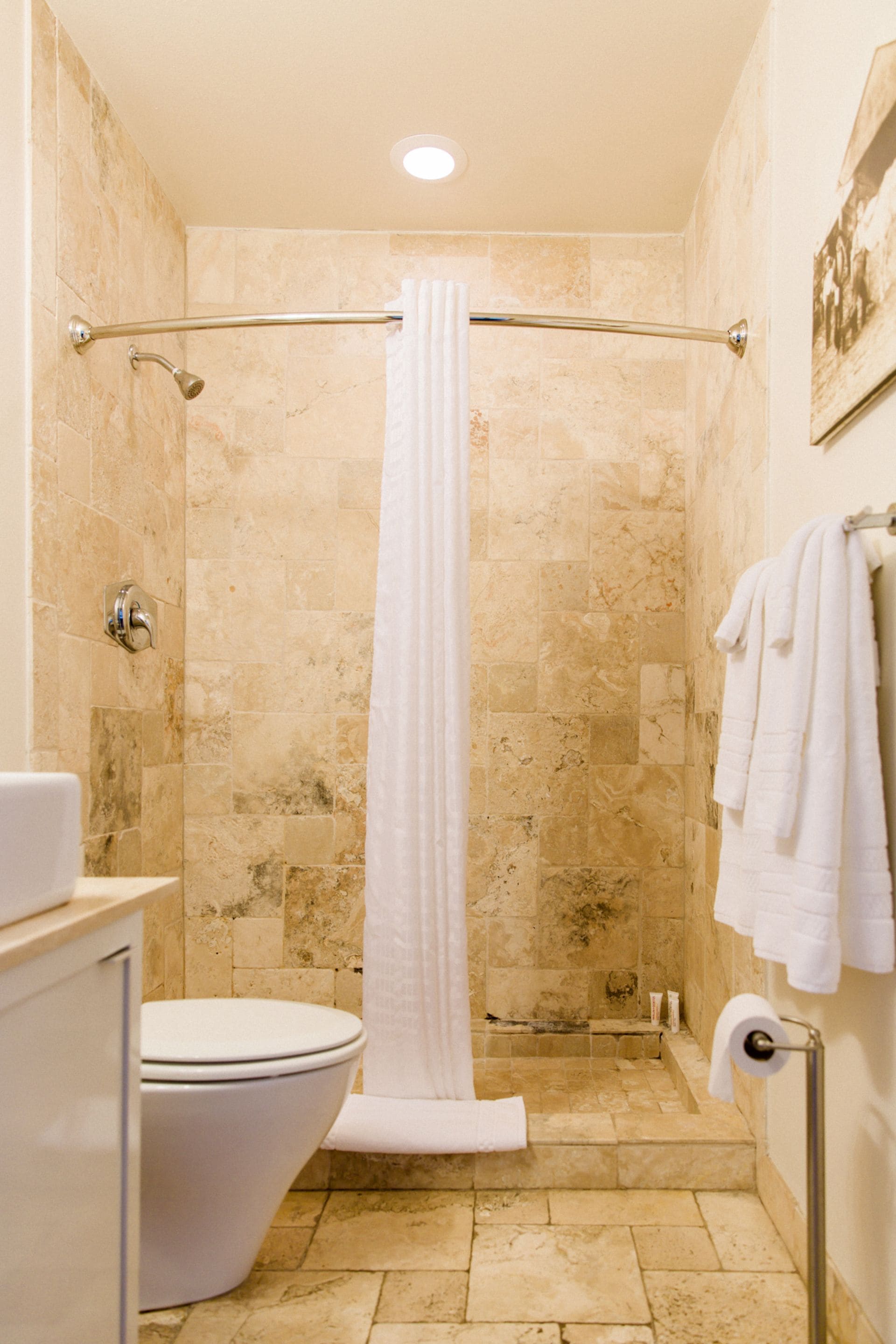 combined shower/bathtub, designer toiletries, hair dryer, towels