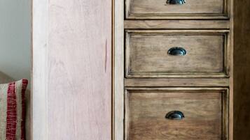 A wooden cabinet with four drawers and a radio on top.