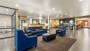 A spacious lobby with blue sofas, a coffee table, and a reception desk. - Comfort Suites El Paso West (El Paso)