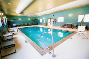 A swimming pool with a lifebuoy, chairs, and a changing room. - Holiday Inn Express Hotel & Suites, a Baton Rouge-Port Allen by IHG (Port Allen)