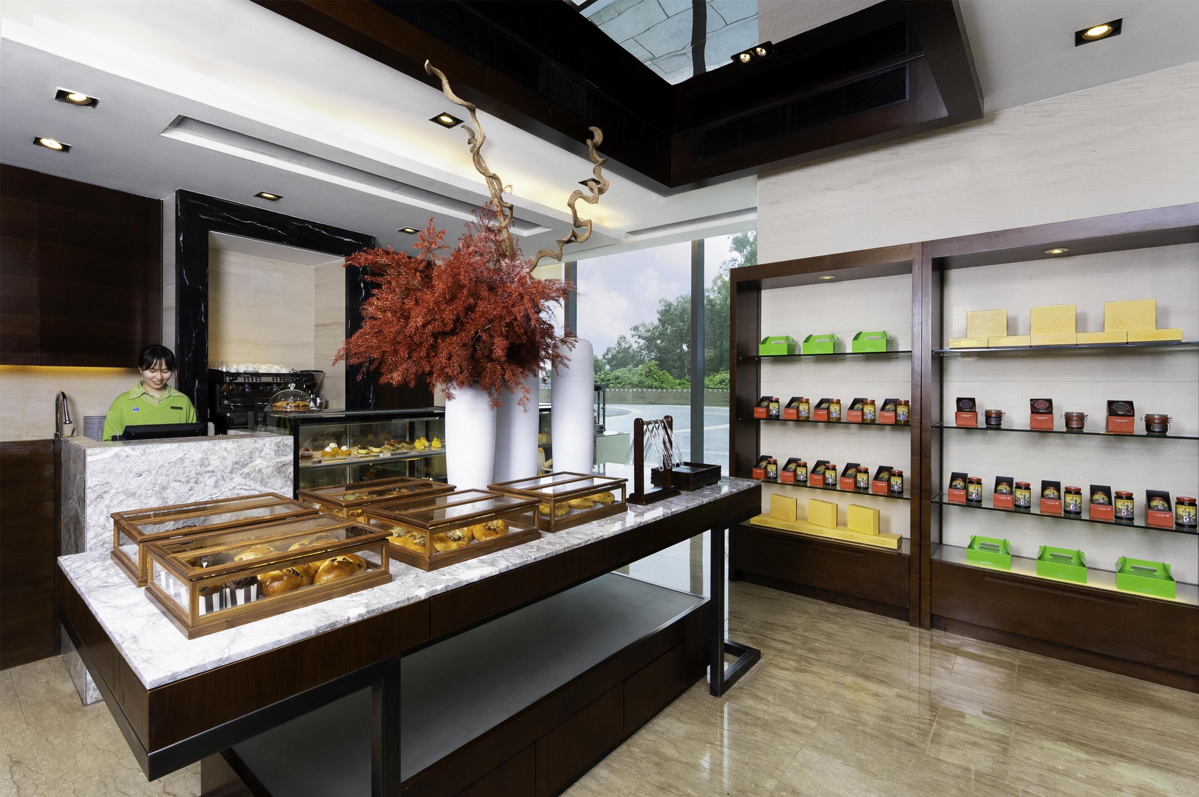 A modern interior with a marble counter, display cases, and shelves of products.