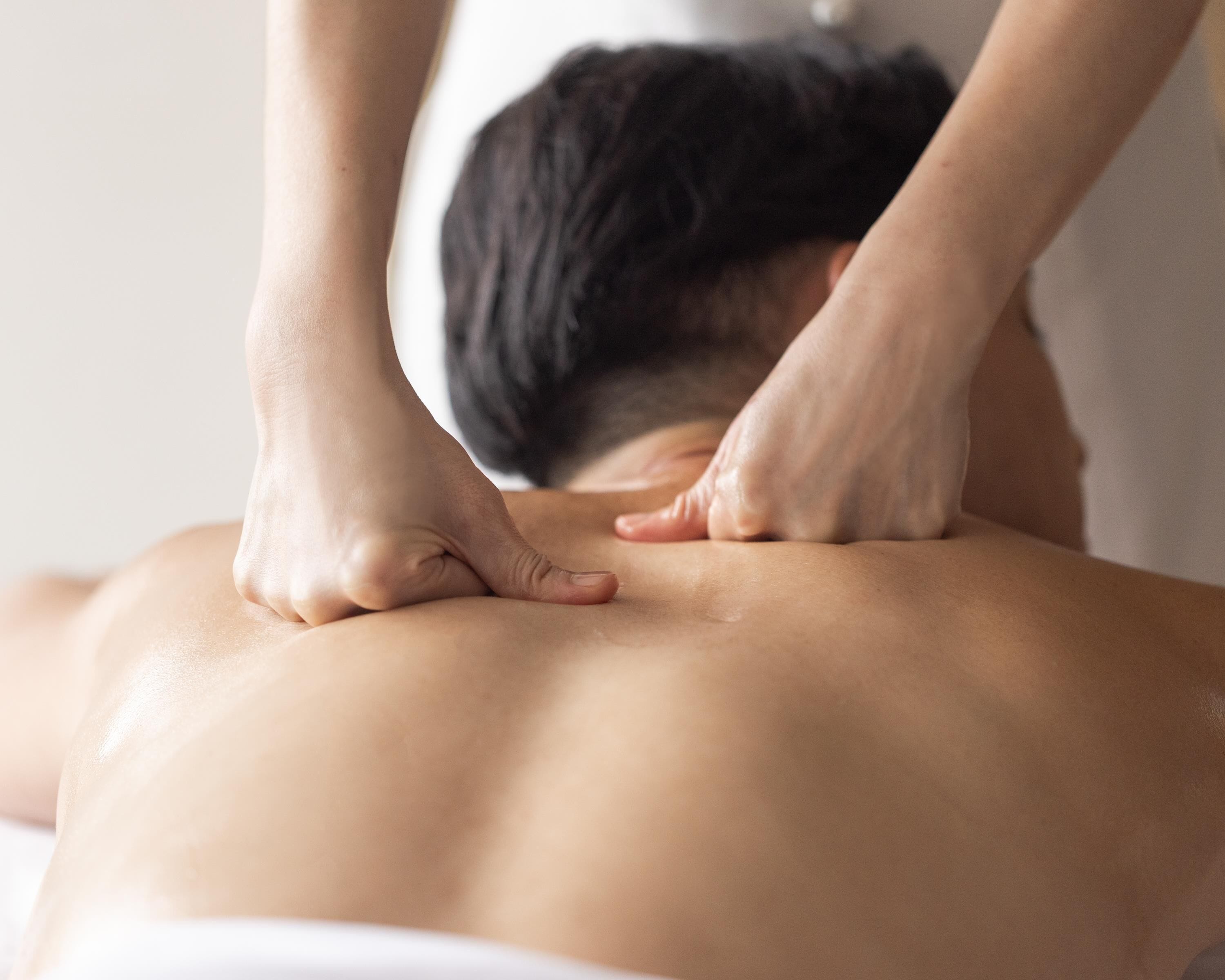 A person receiving a back massage.