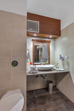 A modern bathroom with a large sink, mirror, and a hairdryer on the wall. - Club Mahindra Snow Peak Manali (Manali)