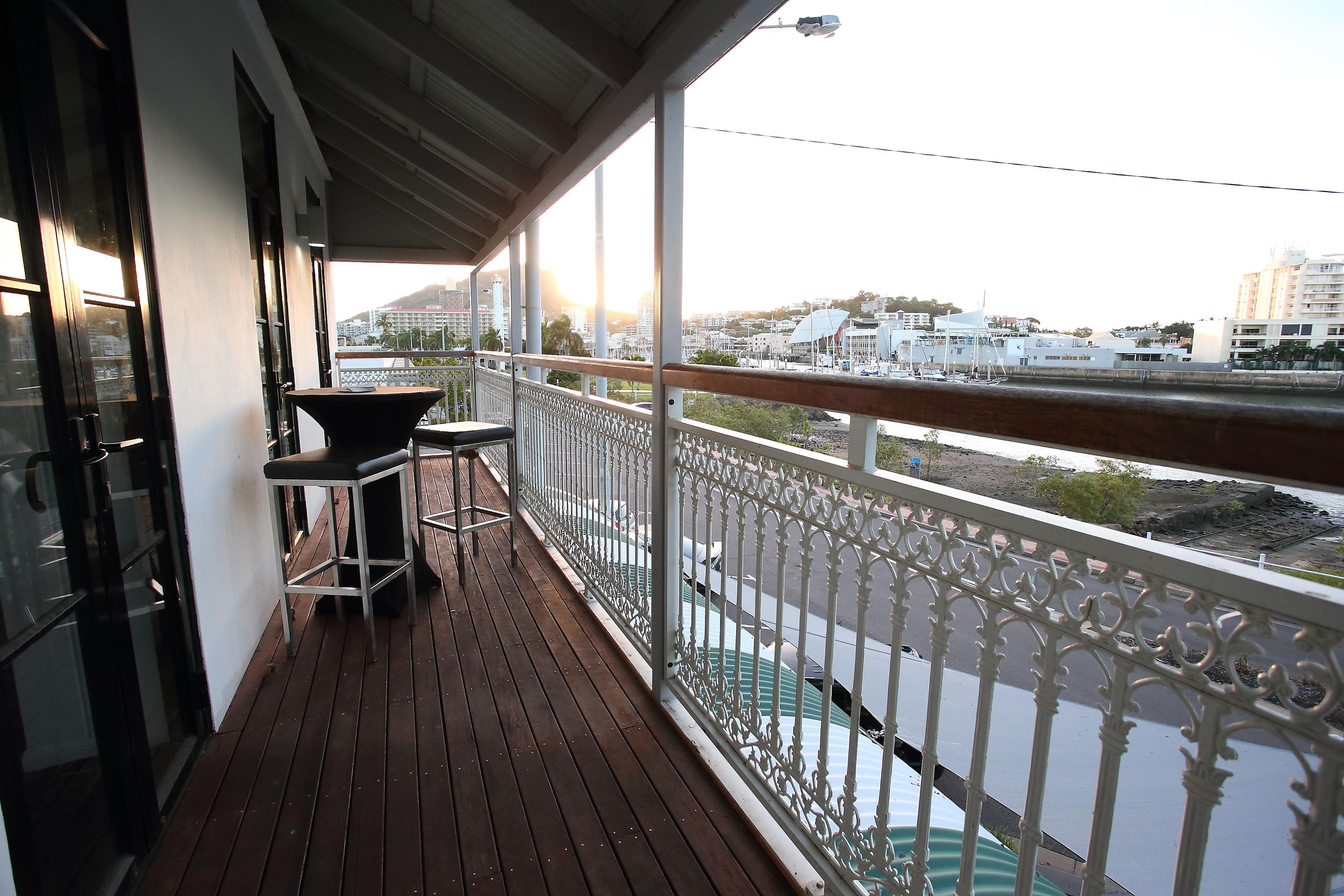 A balcony with a view of a marina and buildings.
