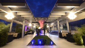 A modern outdoor lounge area with seating, a central decorative structure, and a view of the sky. - The Zuri Whitefield, Bangalore (Bengaluru)