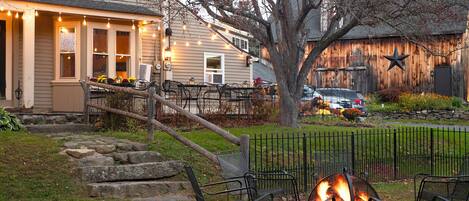 A patio area with outdoor seating and a fire pit.
