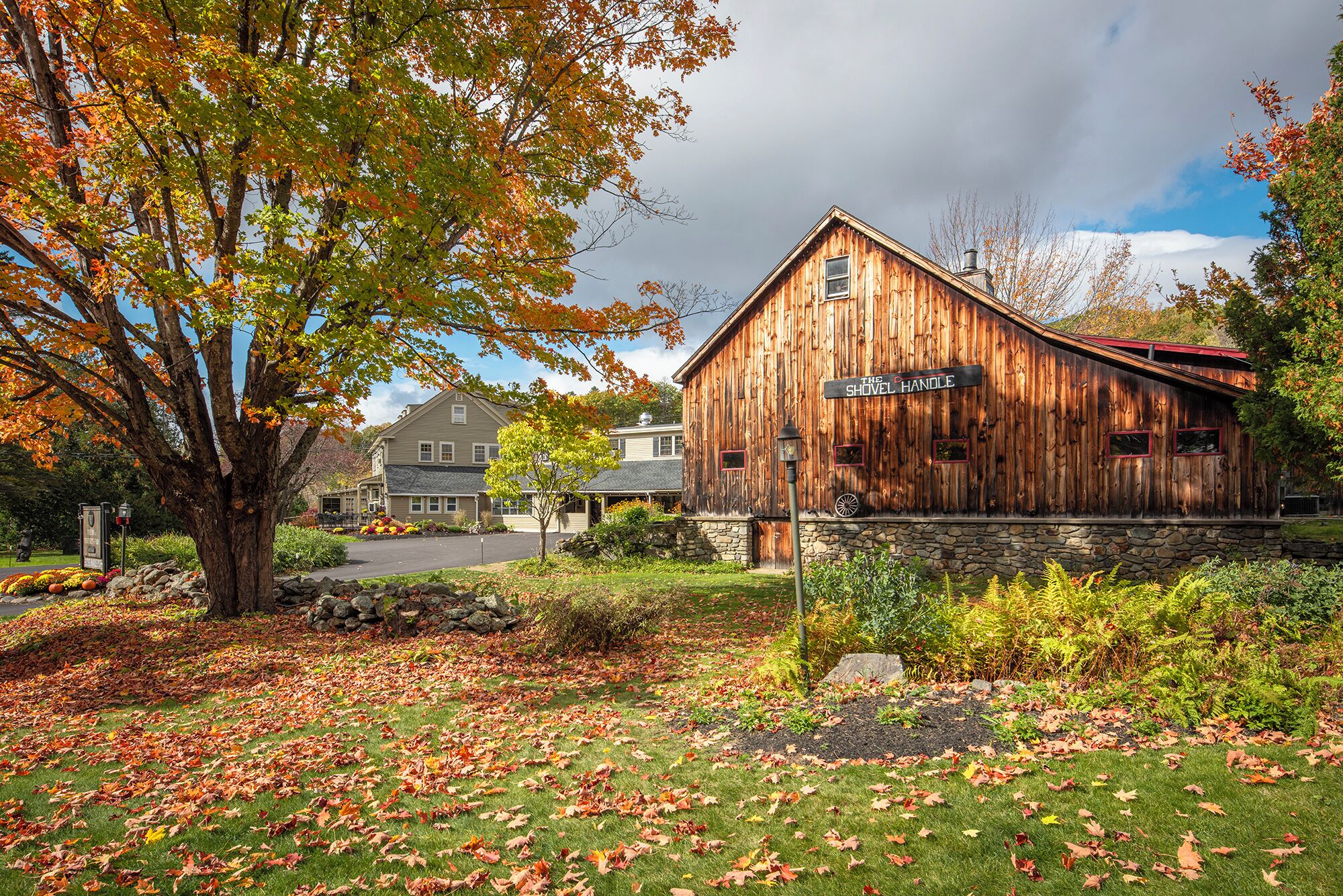 A rustic wooden building with a sign reading "The Shovel Handle."