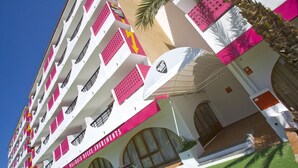 A multi-story building with balconies, a palm tree, and a sign reading "Mallorca Rocks Apartments". - Mallorca Rocks Apartments (Calvia)