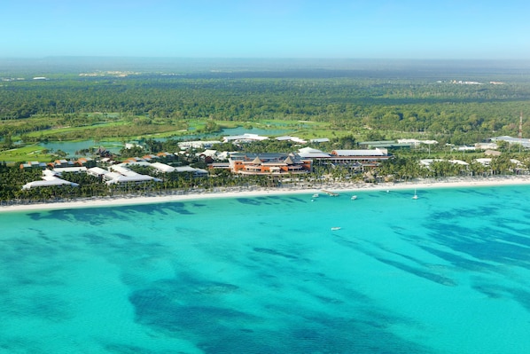 An aerial view of a resort with multiple buildings, a beach, and a golf course. - Barceló Bávaro Palace - All Inclusive (Punta Cana)
