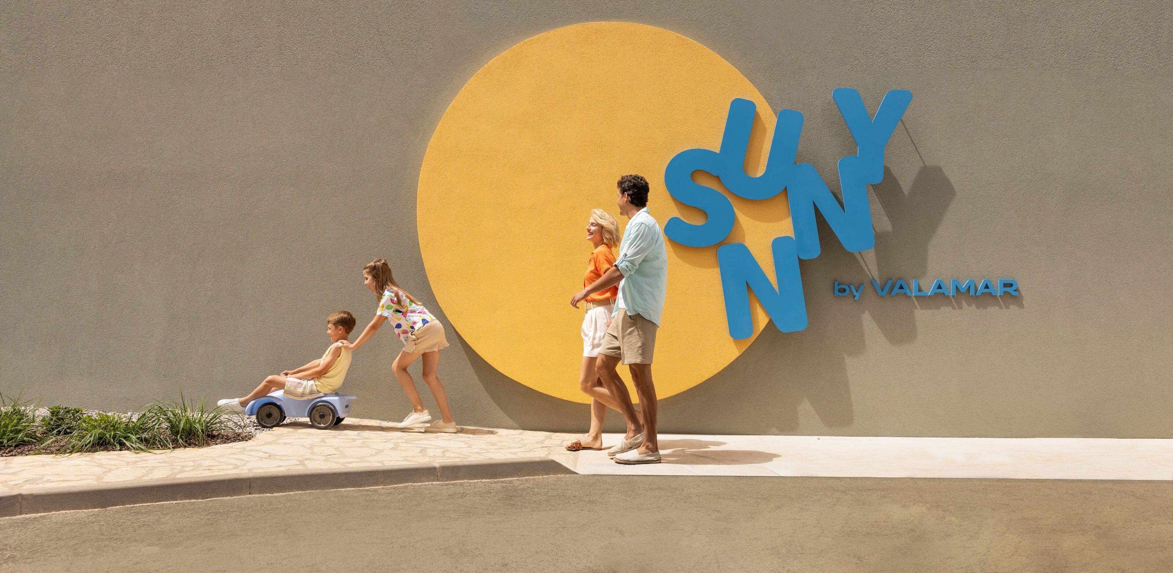 A wall with a large yellow circle and the text "SUNNY by VALAMAR".