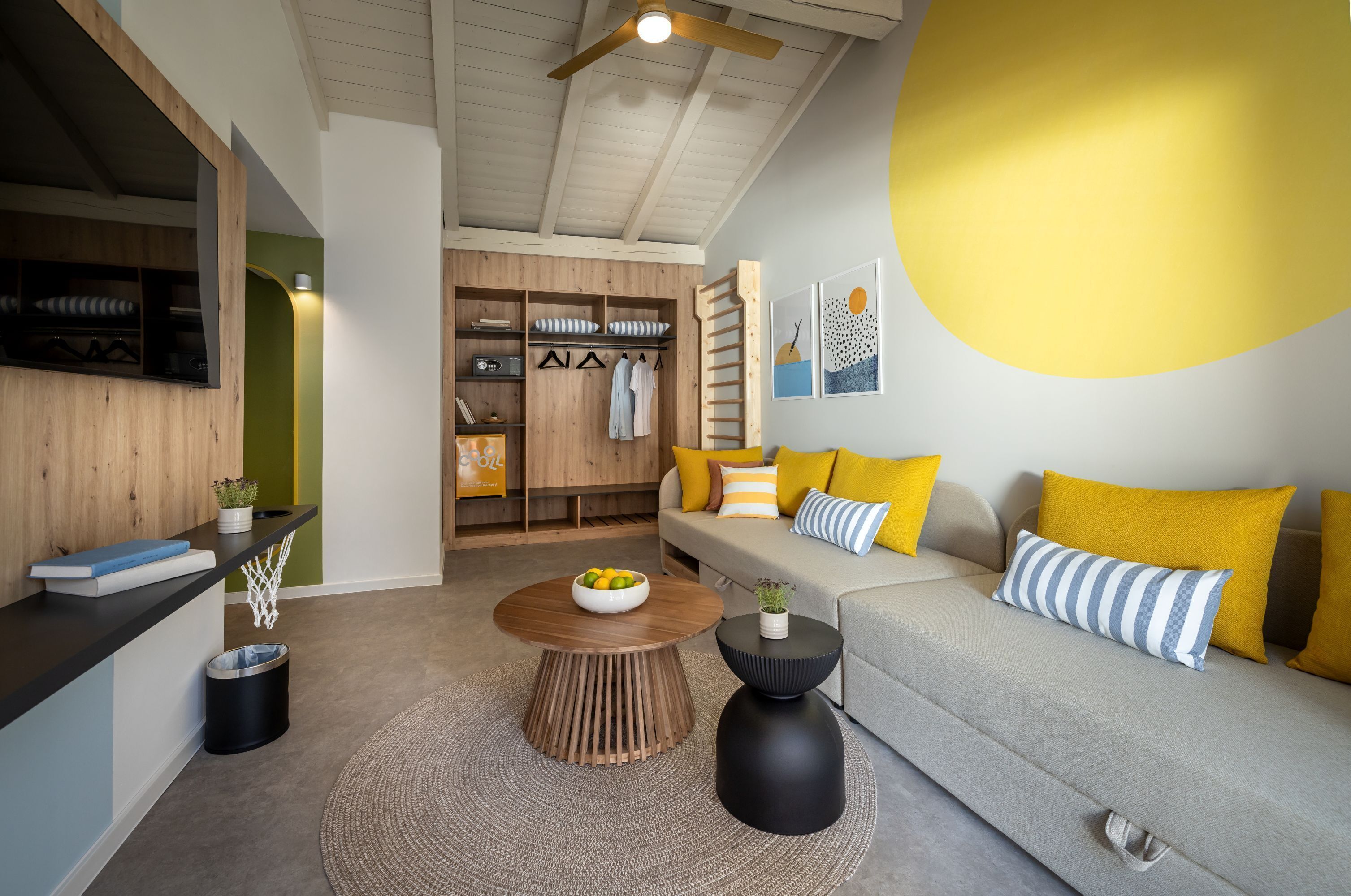 A modern living room with a sofa, coffee table, and a wooden wardrobe.