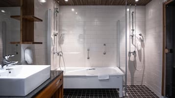 A modern bathroom with a bathtub, a shower, a sink, and a mirror.