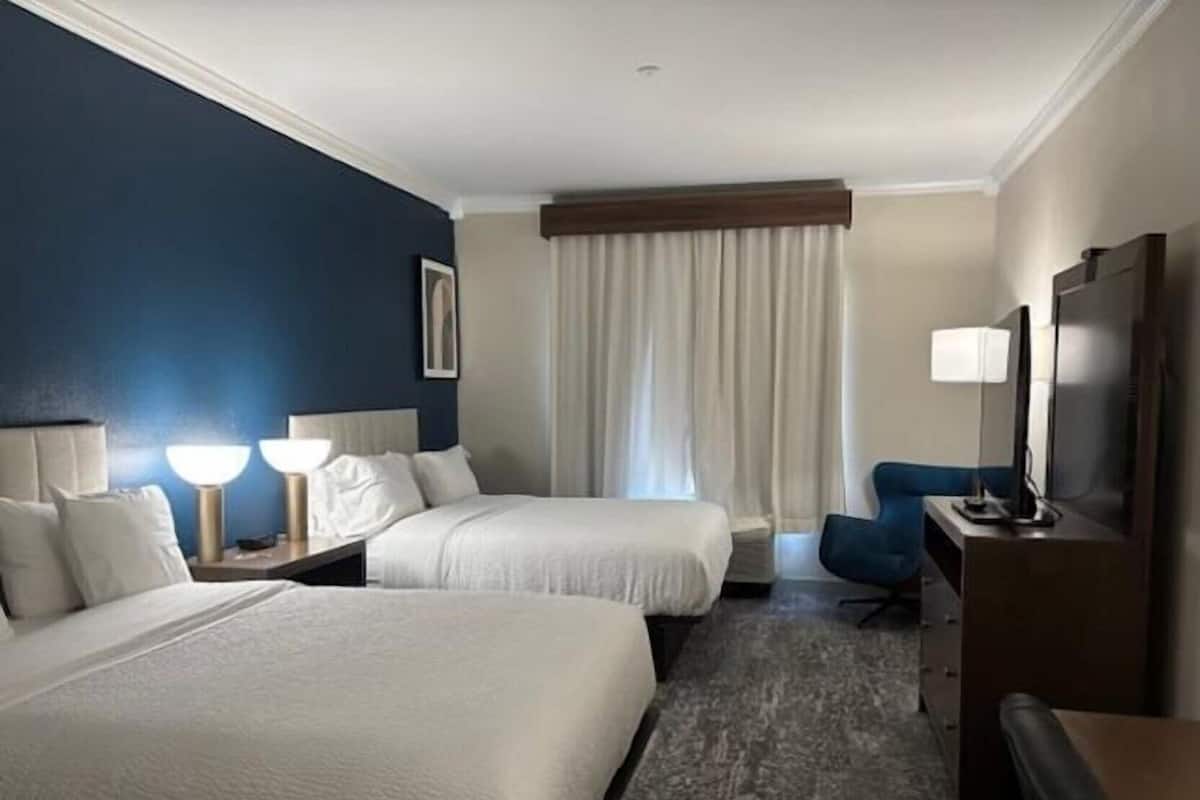 Luxe beddengoed, donsdekens, een bureau, een laptopwerkplek