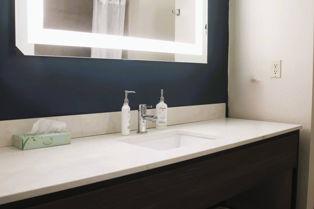 combined shower/bathtub, designer toiletries, hair dryer, towels