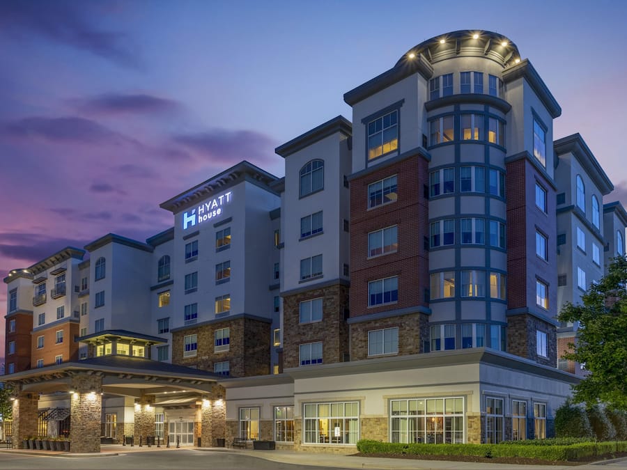 A multi-story hotel with a modern design, featuring a prominent 'Hyatt House' sign.