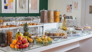 A buffet with various food items and a glass display case. - Phi Hotel Garden Area Roma Eur (Rome)